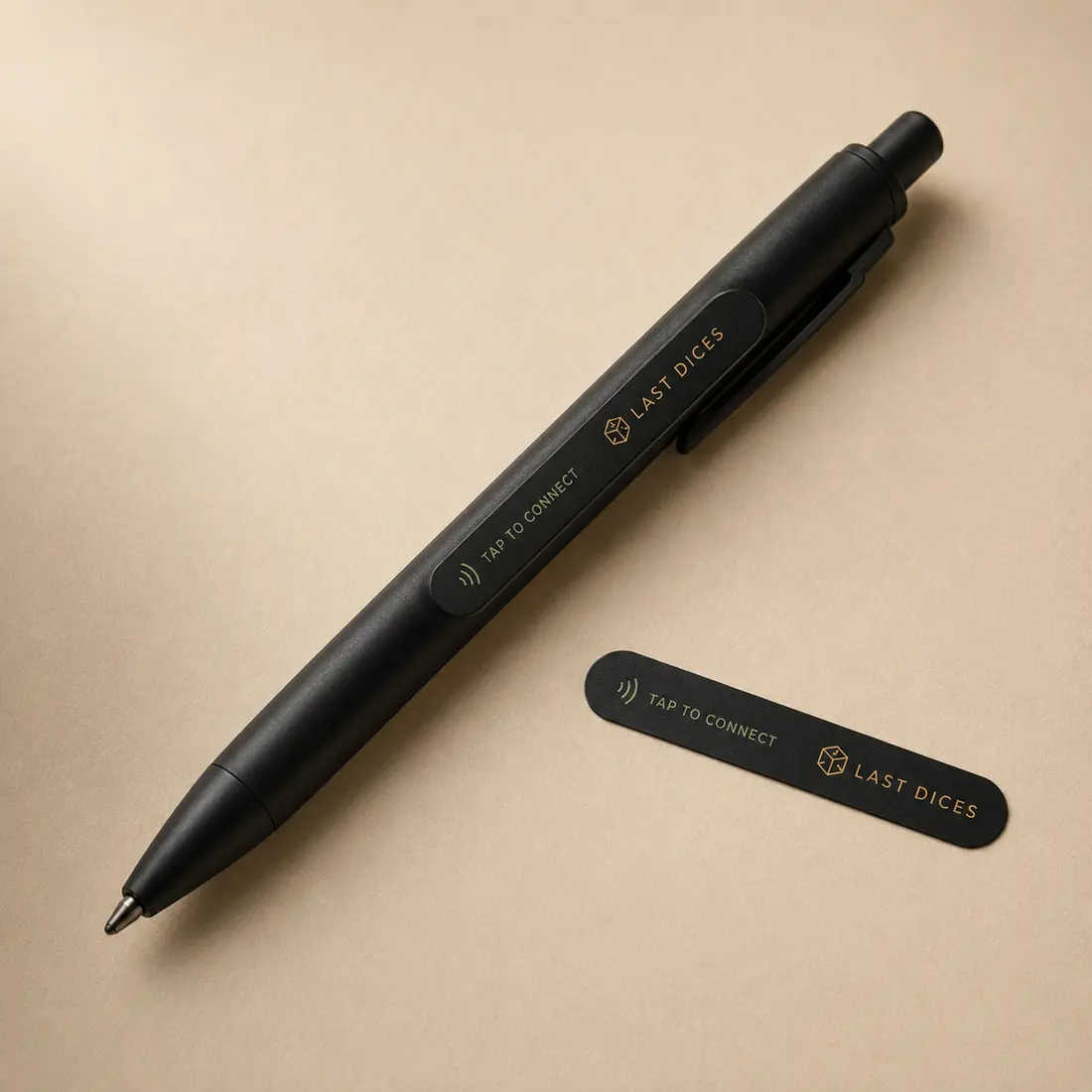 Last Dices PenLink Tap sticker attached to a matte-black pen